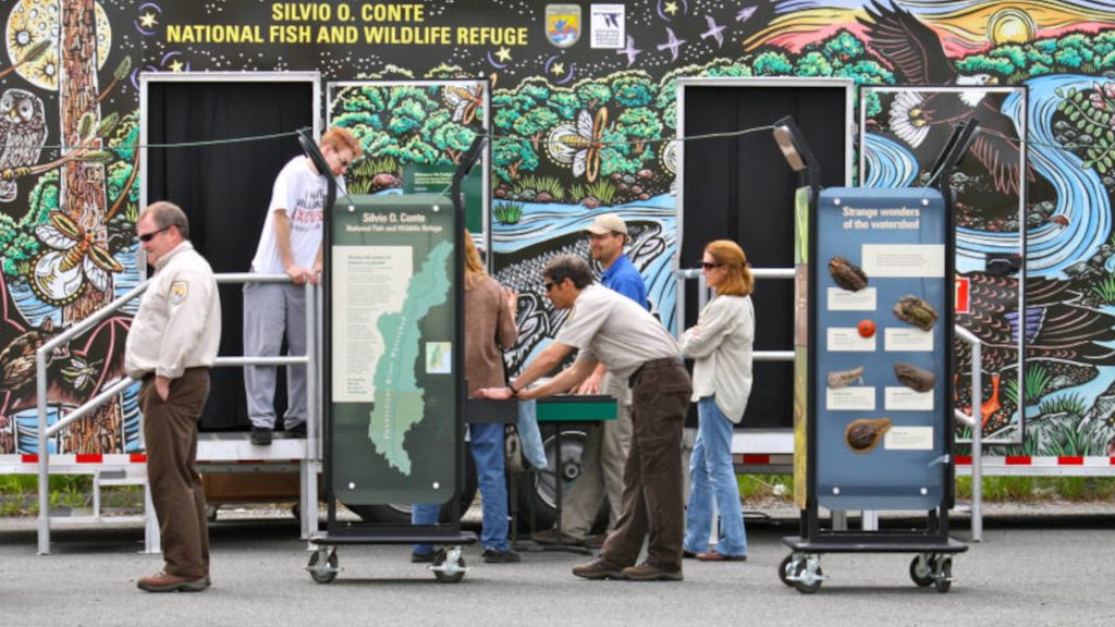 Photo of people engaging with exhibit materials at the Silvio O. Conte National Fish and Wildlife Refure.