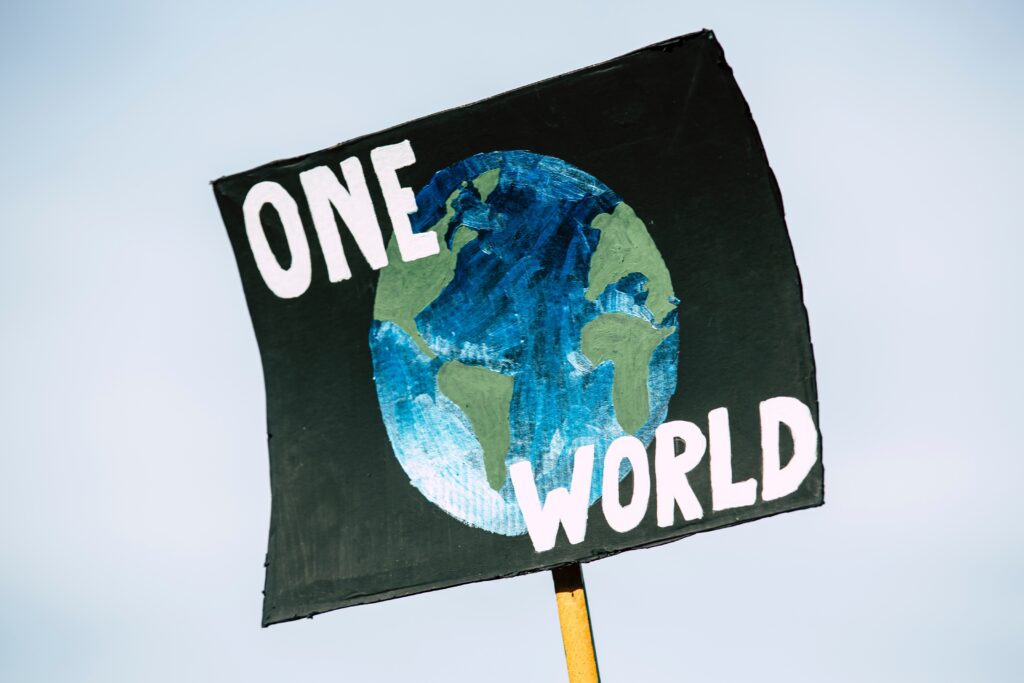 Photo of a sign that says "One World."