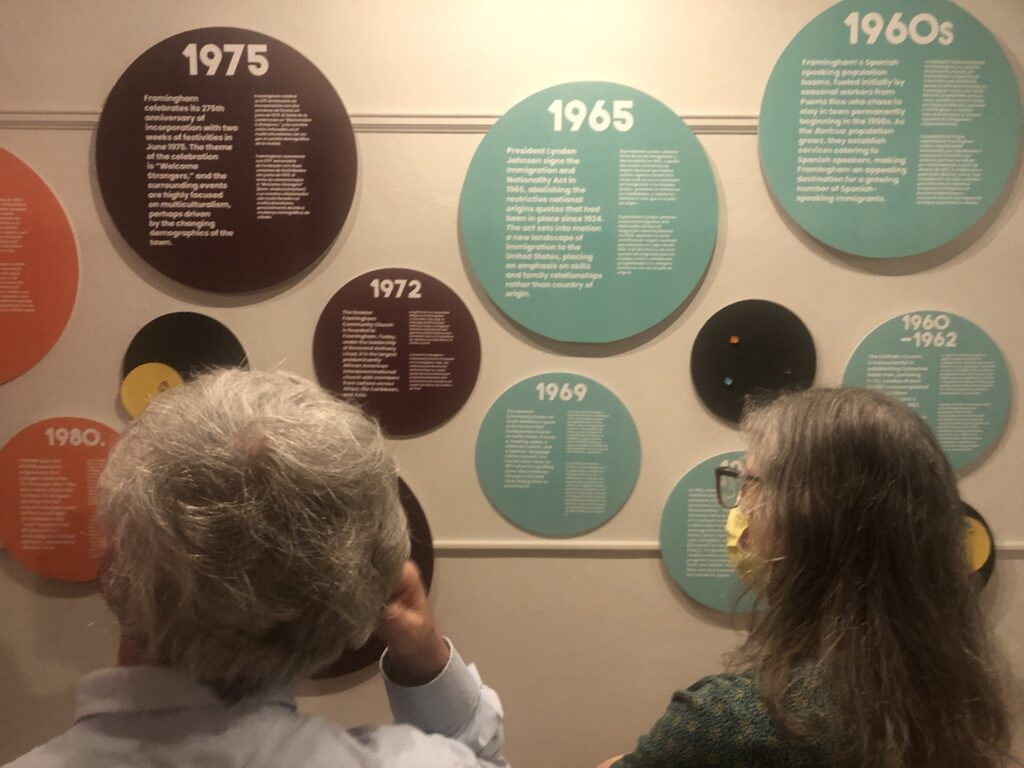 Photo of people looking at an exhibit display.