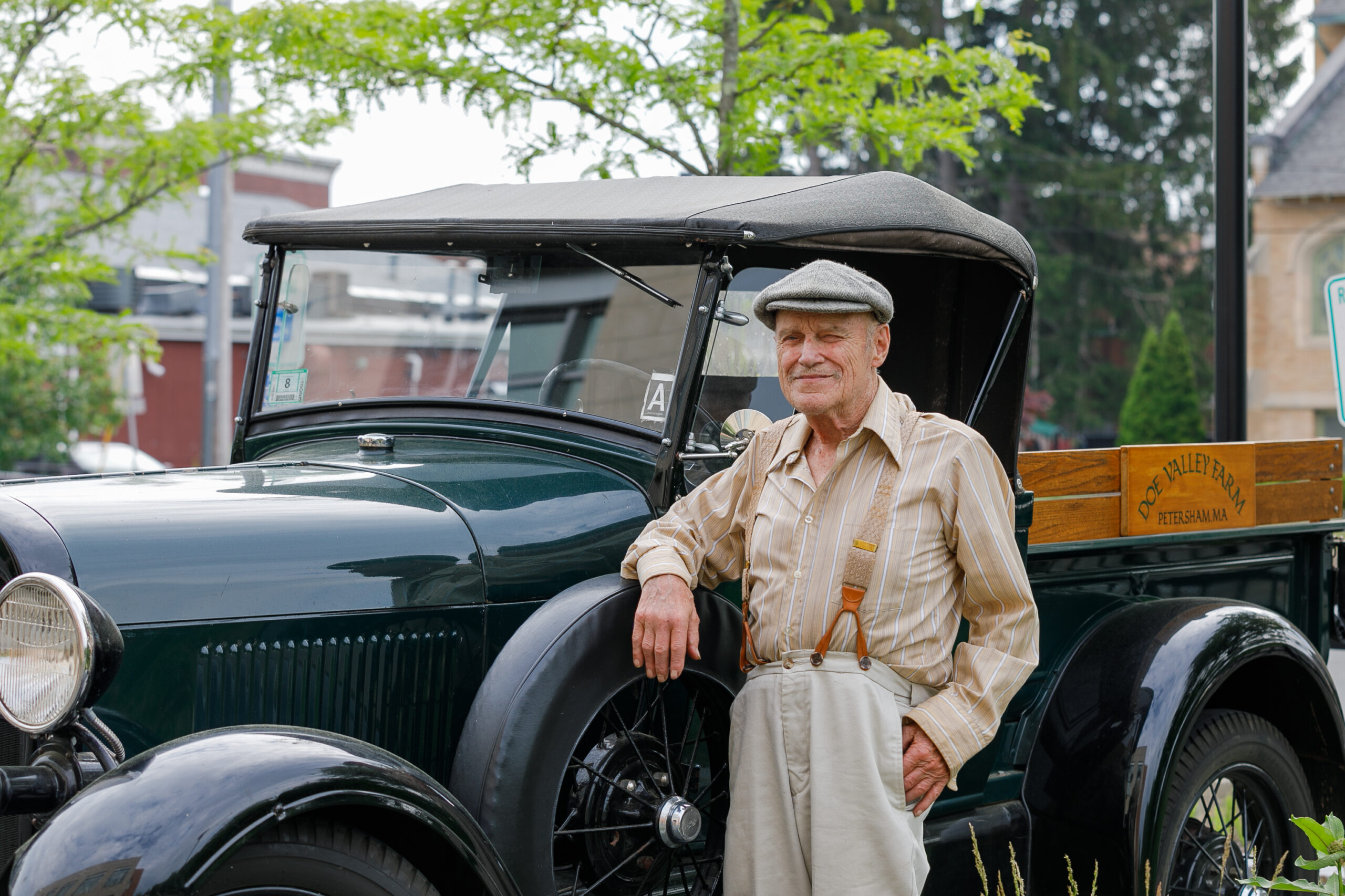 Photo of a man standing in front of a truck.