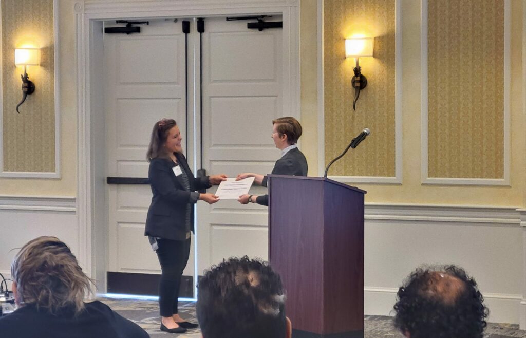 Photo of Anna Tucker, Framingham History Center, receiving the 2024 Mass Commendation award from Katherine Stevens, Director of Grants & Programs at Mass Humanities.