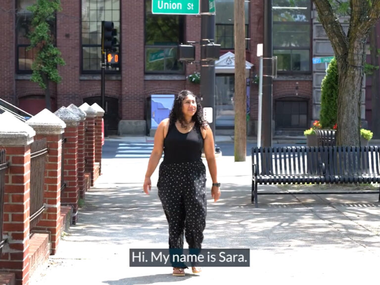 Sara Morin walking on the sidewalk.