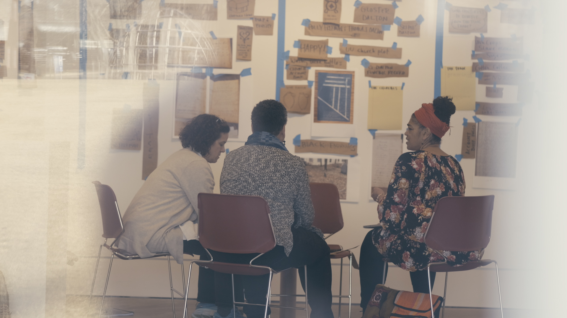 Photo of three women artists in a studio.