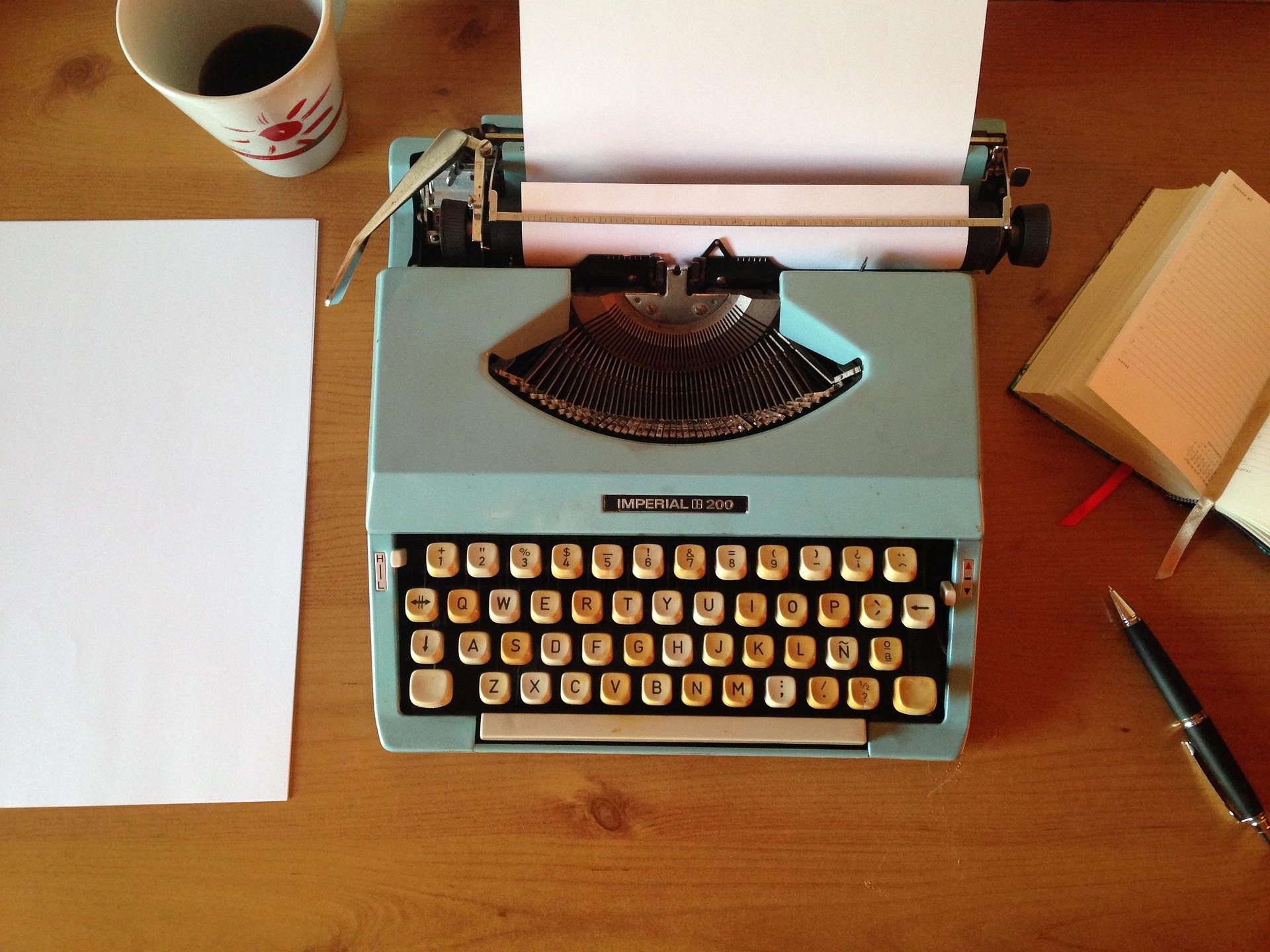 Photo of a typewriter on top of a desk.