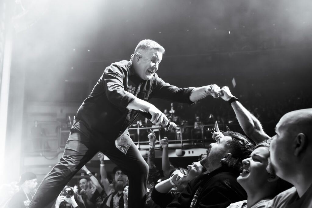 Ken Casey performs on stage.